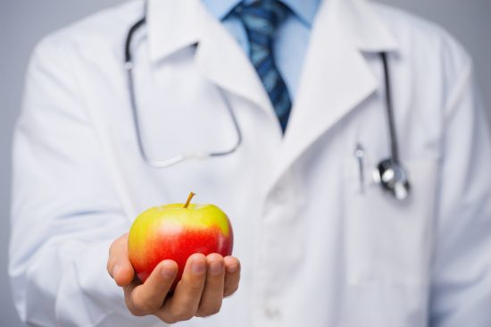 bigstock-Doctor-with-an-apple-74771989