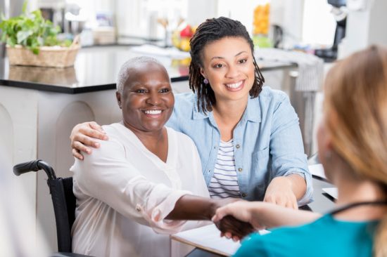 older-woman-and-daughter-at-home-with-nurse